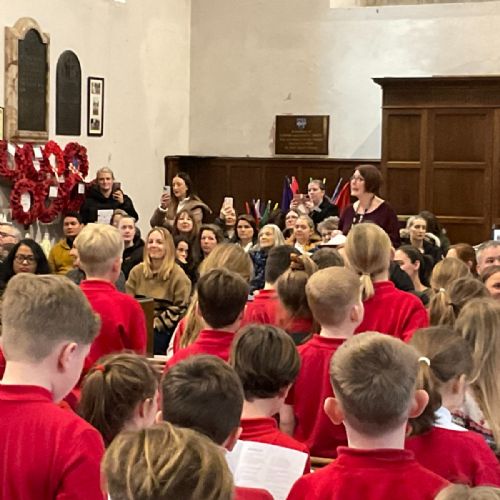Mrs Black leading the children singing